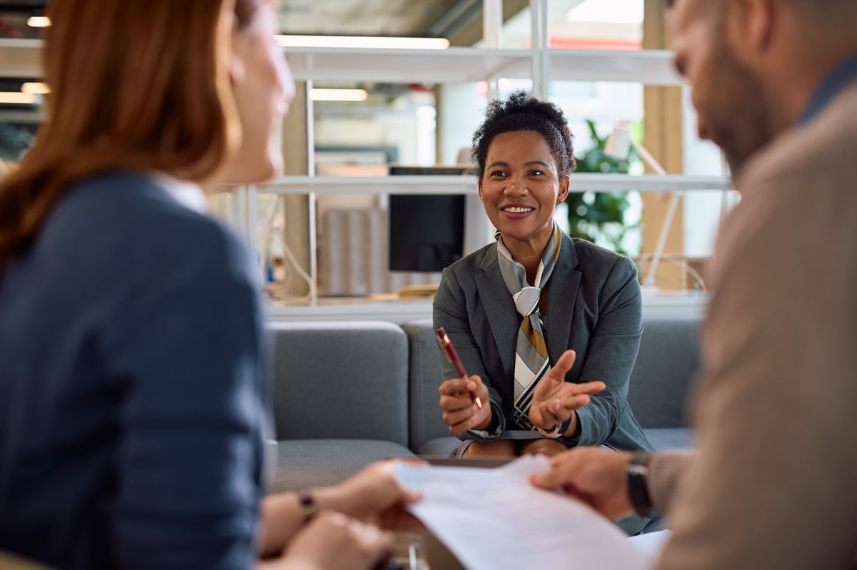 An advisor in a bright office in conversation with the homeowners she is working with